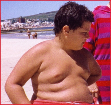 Obese boy on the beach