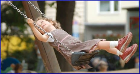 little girl on a swing