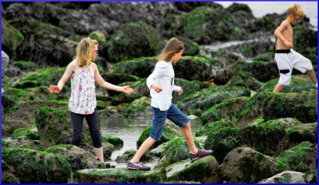 children climbing over the rocks