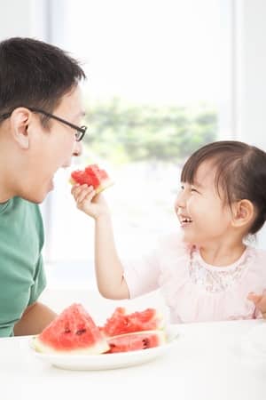 girl-feeding-dad-watermelon
