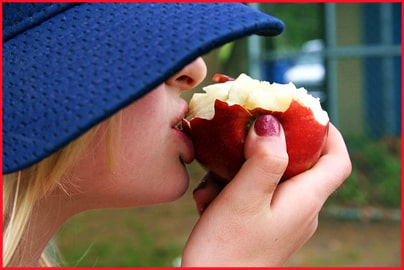 Girl in Hat Eating an Apple